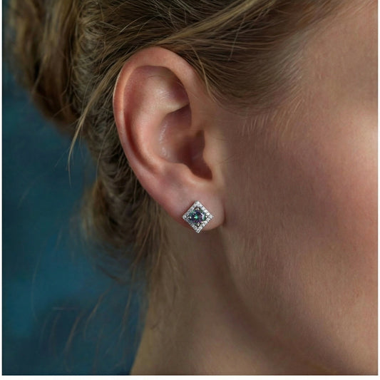 Diamond-shaped sterling silver stud earrings with rainbow moissanite centers surrounded by crystal halos